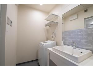 a bathroom with a sink and a washing machine at Hotel Celeste Shizuoka Takajo - Vacation STAY 94099v in Shizuoka