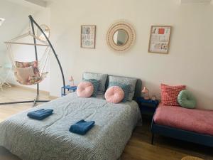 um quarto com uma cama com almofadas azuis em cocooning modern design studio em Avesnes-sur-Helpe