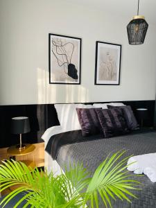 a bedroom with a bed with three pictures on the wall at Motlawa Inn Apartment-Suna,Gym&Parking in Gdańsk