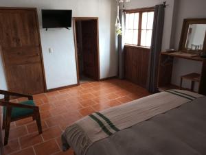 a bedroom with a bed and a tiled floor at Casa Macetas in San Miguel de Allende