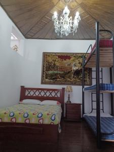 a bedroom with a bunk bed and a chandelier at Hostal Mirador Andino in Manizales