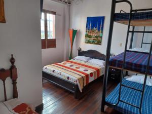 a bedroom with a bed and a bunk bed at Hostal Mirador Andino in Manizales