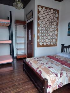 a bedroom with a bed and a wooden floor at Hostal Mirador Andino in Manizales