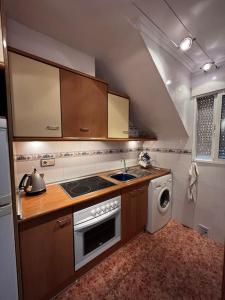 a kitchen with a stove and a sink and a dishwasher at Great Sun Terrace Close to Beach in Gran Alacant
