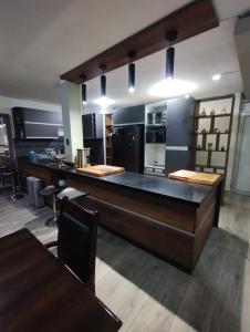 a large kitchen with a large counter and tables at Casa de Juli in Huancayo