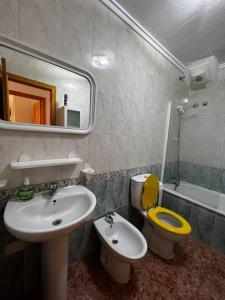 a bathroom with a sink and a toilet and a mirror at Great Sun Terrace Close to Beach in Gran Alacant