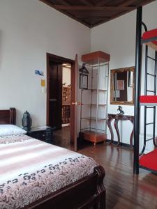 a bedroom with a bed and a book shelf at Hostal Mirador Andino in Manizales