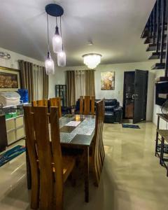 a dining table and chairs in a living room at 3 Bedroom Furnished House near SM CDO uptown in Cagayan de Oro