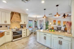 a kitchen with white cabinets and a dining room at Sedona's Paradise Found, Saltwater Pool and Hot Tub, plus CanAm Ride! in Sedona