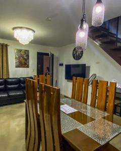 a dining room with a glass table and chairs at 3 Bedroom Furnished House near SM CDO uptown in Cagayan de Oro