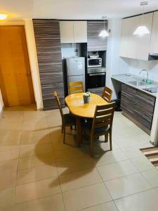 a kitchen with a wooden table and chairs in a room at APARTAMENT IN PENINSULA IQUIQUE(NEAR OF ALL) in Iquique