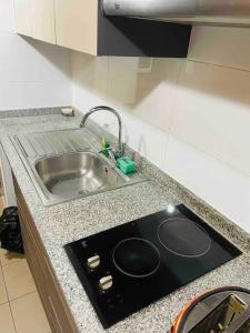 a kitchen counter with a sink and a stove at APARTAMENT IN PENINSULA IQUIQUE(NEAR OF ALL) in Iquique