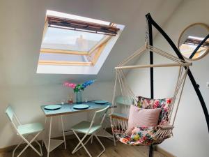 a room with a hammock chair and a table at cocooning modern design studio in Avesnes-sur-Helpe
