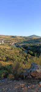 a view of a field with a town in the distance at Casa Sardinha 