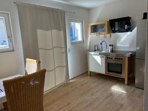 a small kitchen with a sink and a stove at Boardinghouse Rheinfelden 1 in Rheinfelden