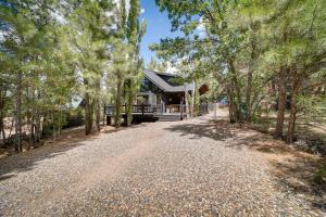 a gravel road in front of a house with trees at Peaceful Cabin Between Flagstaff and Sedona! in Munds Park