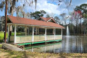 a pavilion in the middle of a pond with a fountain at Totally Rad Pad! in Midway