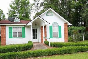 a small house with green and white paint on it at Totally Rad Pad! in Midway +4 photos