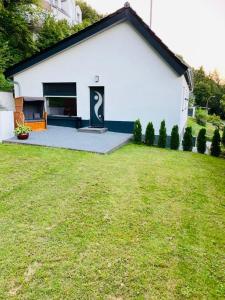 a white house with a lawn in front of it at Wellness Ferienhaus in Mechernich