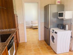 a kitchen with a refrigerator and a washing machine at VillaMar in Villaverde