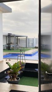 a view of a swimming pool from a building at bh villa in Al Ashkharah