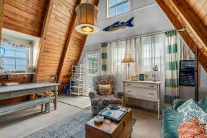 a living room with a piano and a desk at Anchor's Holding in Holden Beach