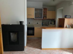 a kitchen with a stove and a counter top at Appartamento Ari in Vermiglio +15 photos
