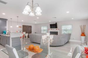 a kitchen and a living room with a glass table at Y&M TAMPA SWEET HOME! in Tampa