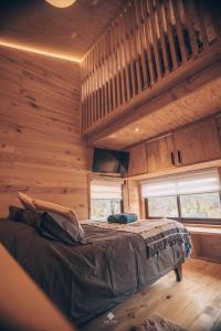 a bedroom with a bed in a wooden cabin at Yuki Yama in Malalcahuello