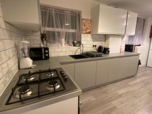 a kitchen with a stove and a counter top at House in Walthamstow in London