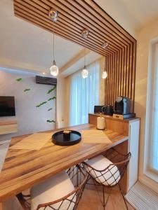 a dining room with a wooden table and chairs at Lavish Inn Apartment in Cluj-Napoca