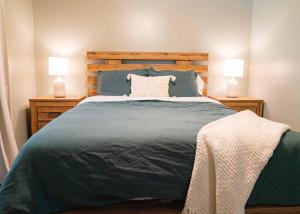 a bedroom with a large bed with two lamps at Cozy Coastal Haven-Private Pool & Outdoor Kitchen in Fort Walton Beach