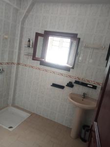 a bathroom with a sink and a window at Villa sidi Bouzid in El Jadida