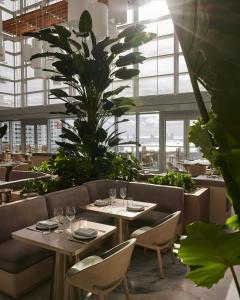 a restaurant with tables and chairs and a palm tree at Brickell Bliss - Luxury Condo in Miami