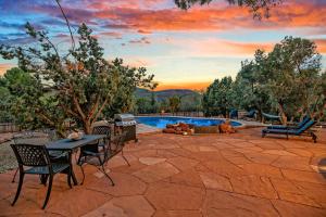 a patio with a table and chairs and a pool at Sedona's Paradise Found, Saltwater Pool and Hot Tub, Private Oasis! in Sedona