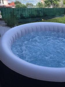 a large hot tub with blue water in a backyard at Apartmaji Koper - MARINA STYLE in Koper