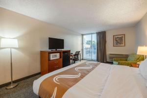 a hotel room with a bed and a flat screen tv at Quality Inn & Suites Canon City in Canon City