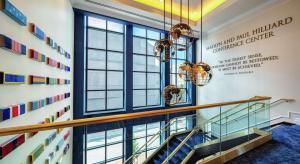 a staircase in a building with a sign on the wall at Higgins Hotel, Official Hotel of The National WWII Museum, Curio Collection by Hilton in New Orleans