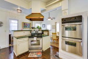 a kitchen with stainless steel appliances and a dining room at Central Albany Home with Covered Porch and Patio! in Albany