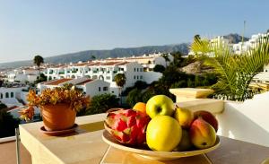 阿德赫的住宿－Costa Adeje - Amazing Ocean And Teide View - Fast WiFi, Air Con，阳台上的桌子上放着一碗水果