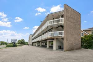 a building with a parking lot in front of it at Budget Inn-Norfolk, VA - Oceanview in Norfolk