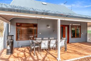 a patio with a table and chairs on a house at Welcoming Ambiant 3BR Abode in Tanunda