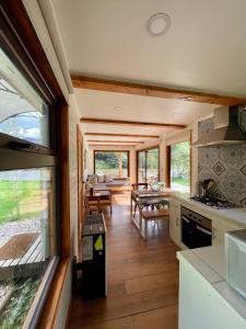 a kitchen and dining room of a tiny house at Huella Patagonia Lodge in Puerto Dunn