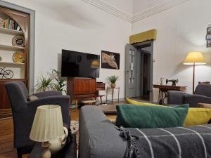 a living room with a couch and a tv at Mont' Sobro House in Évora