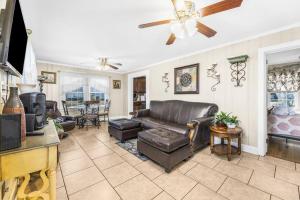 a living room with a couch and a tv at Dazzling Centrally Located Ocean View w 2 Kings, Huge Private Yard, 2 Decks, Firepit, BBQ in Myrtle Beach +47 photos