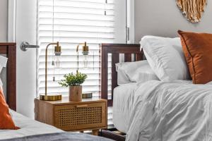 a bedroom with a bed and a table with a plant on it at City View BOHO Apt Stocked w everything you need in Salt Lake City