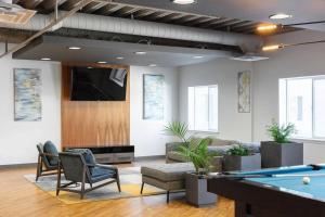 a living room with a pool table and a tv at Charming Downtown Getaway in Salt Lake City