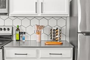 a kitchen with white cabinets and a counter with utensils at Central City Escape in Salt Lake City +30 photos