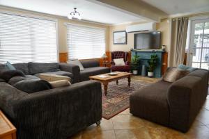 a living room with two couches and a tv at Montrose on Moore in Linville