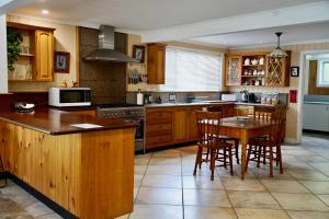 a kitchen with wooden cabinets and a table and chairs at Montrose on Moore in Linville